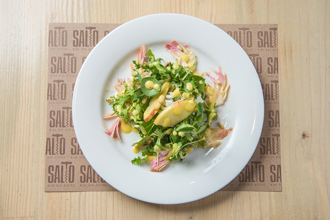 a plate of salad on a place mat